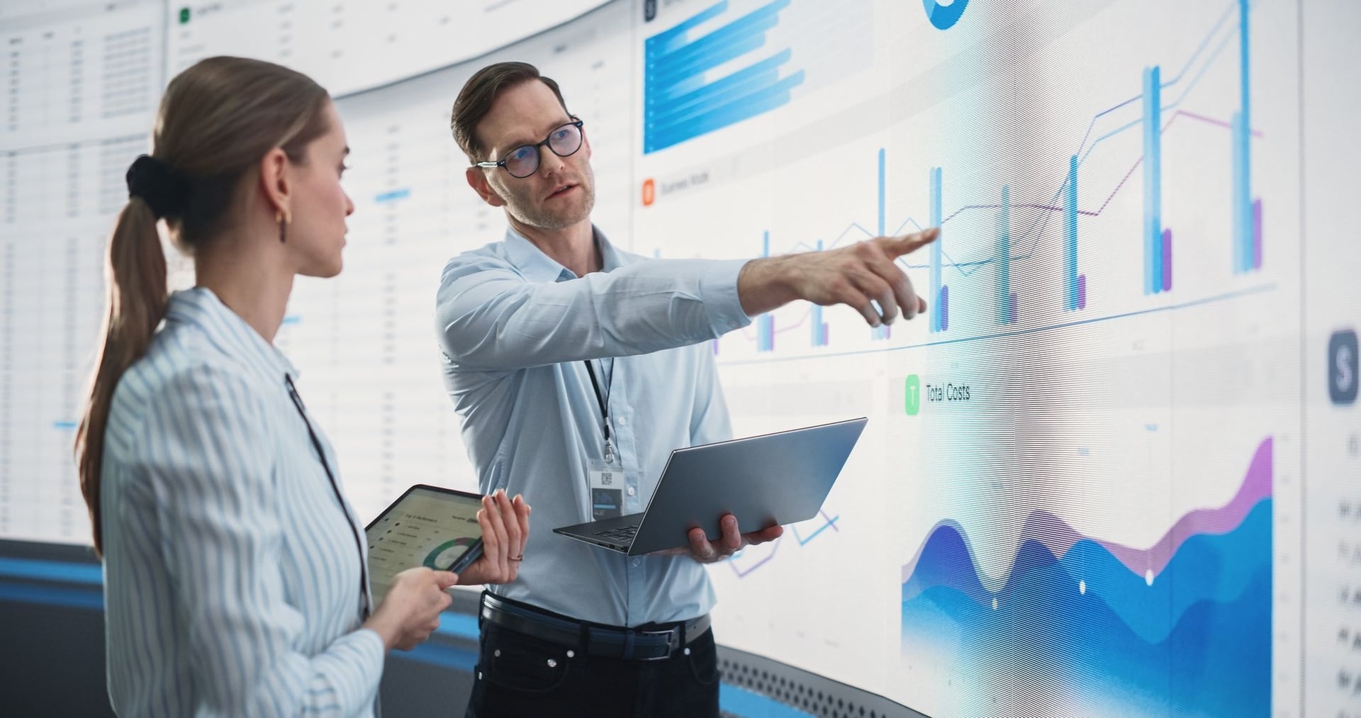 Two software engineers analyzing the data to help the data grow