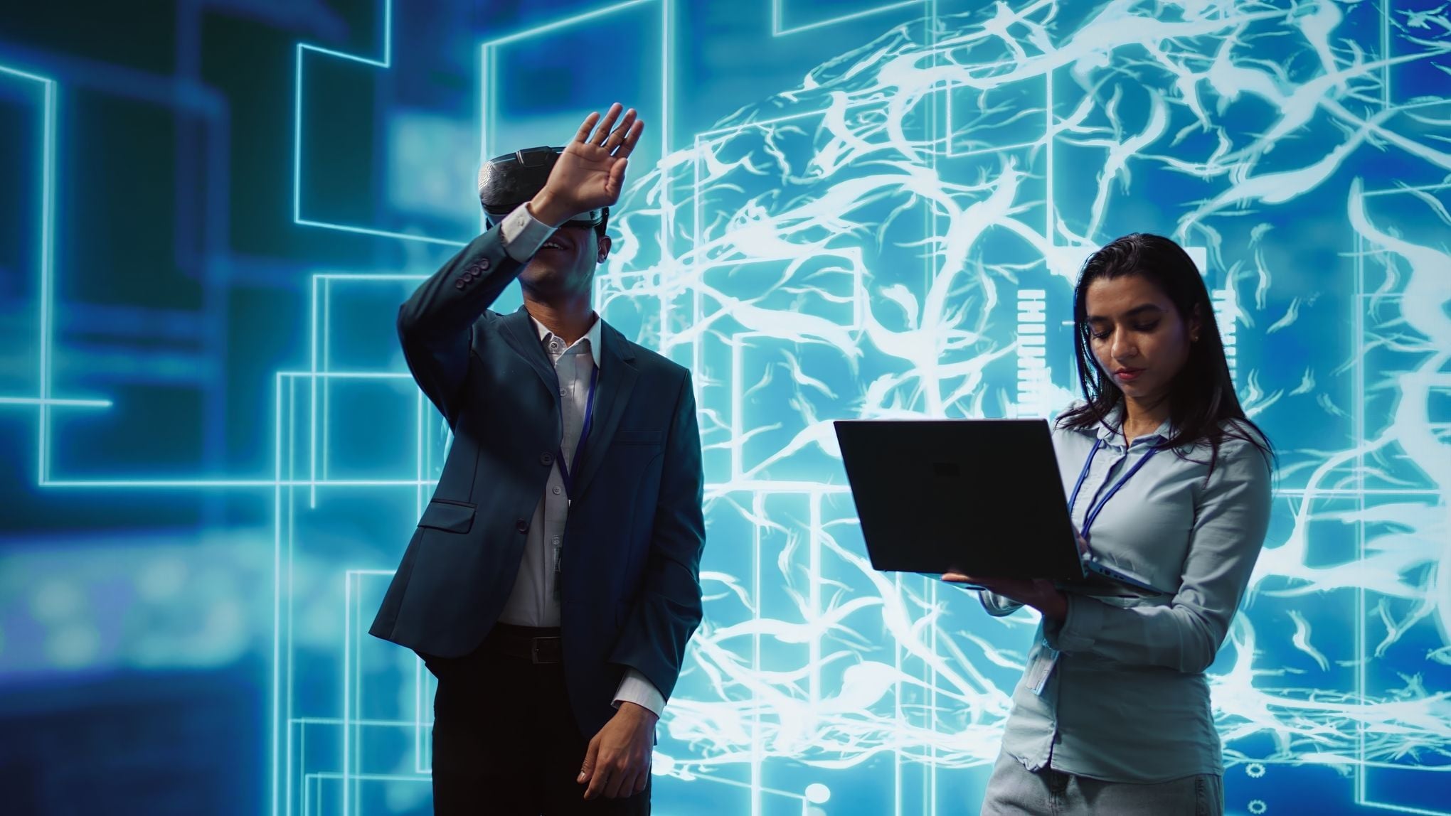 Two software engineers working in a high-tech laboratory, collaborating on a monitor to develop and fine-tune agentic AI automation systems.